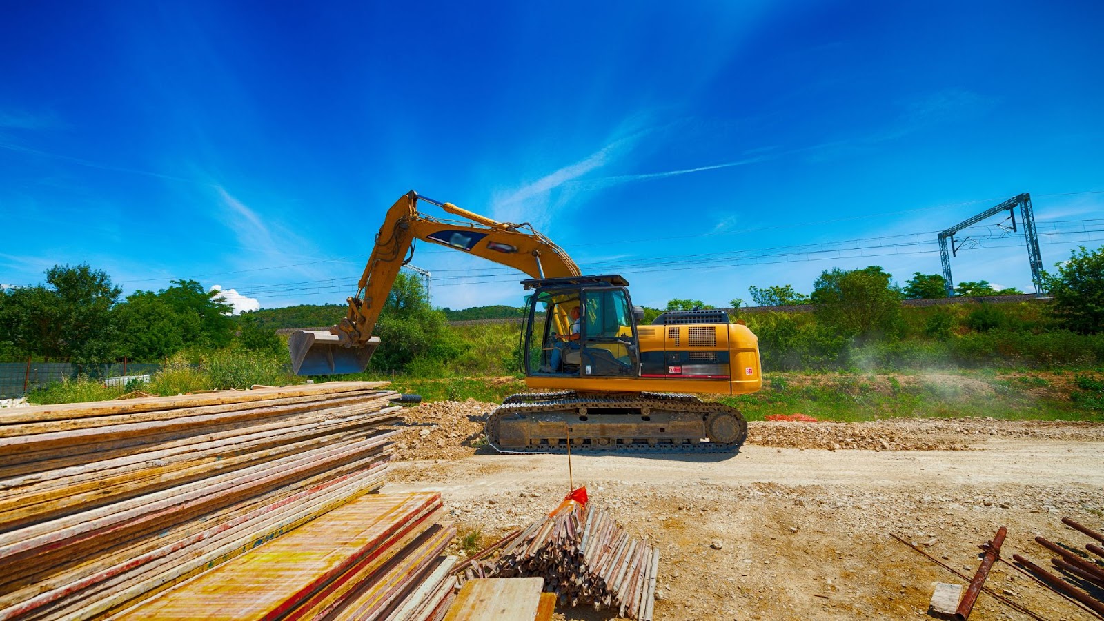 Excavator is working on a pile of wood.