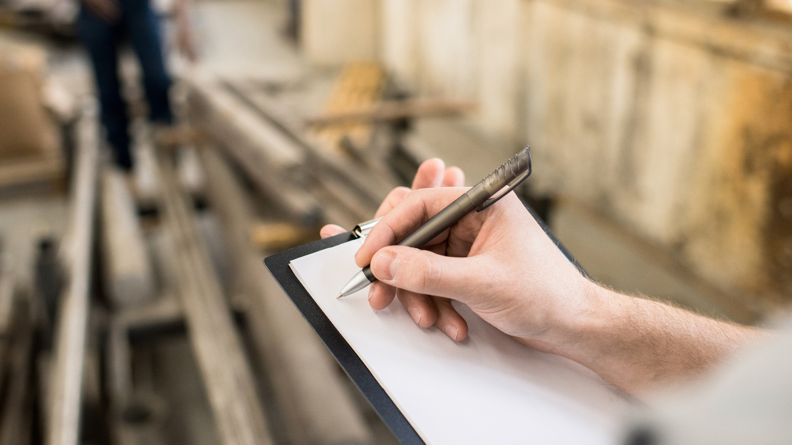 Person writing on a clipboard.