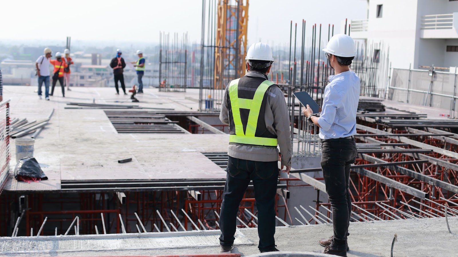 Two construction workers standing on a construction site