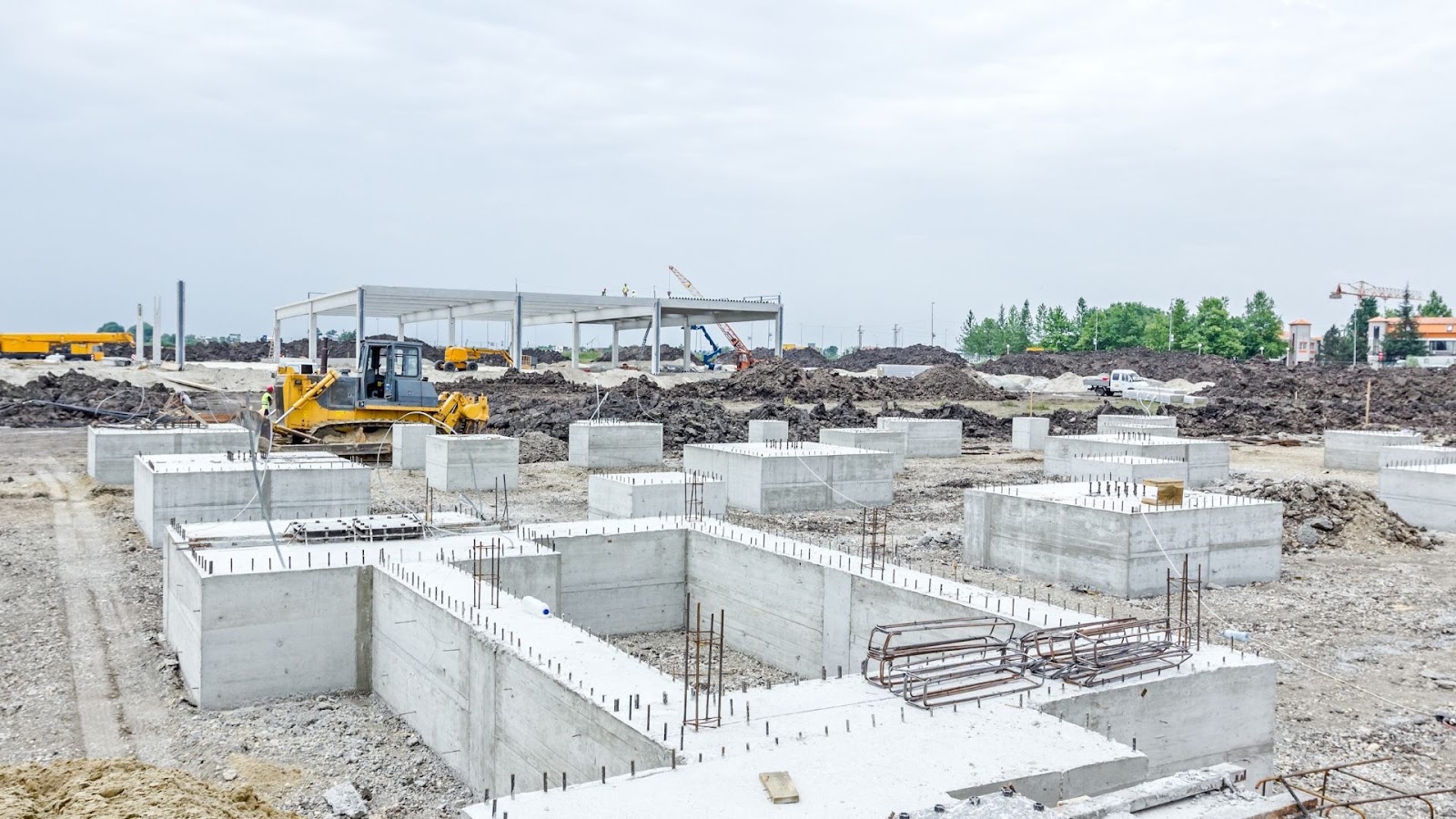 Construction site with concrete blocks and a bulldozer.