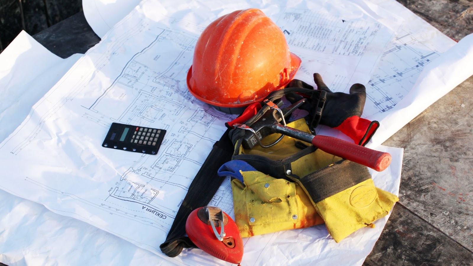 Hard hat and tools laying on top of a piece of paper