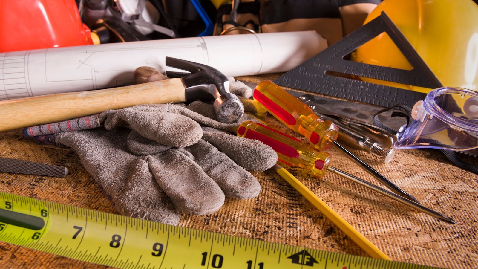 Construction tools on a table with a ruler.