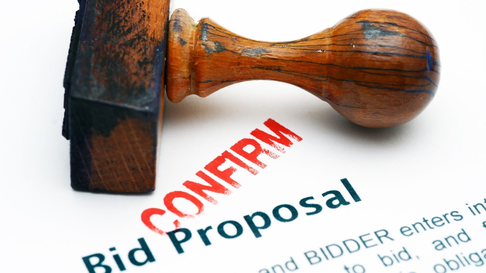 A bid proposal on a piece of paper with a rubber stamp that says bid proposal.