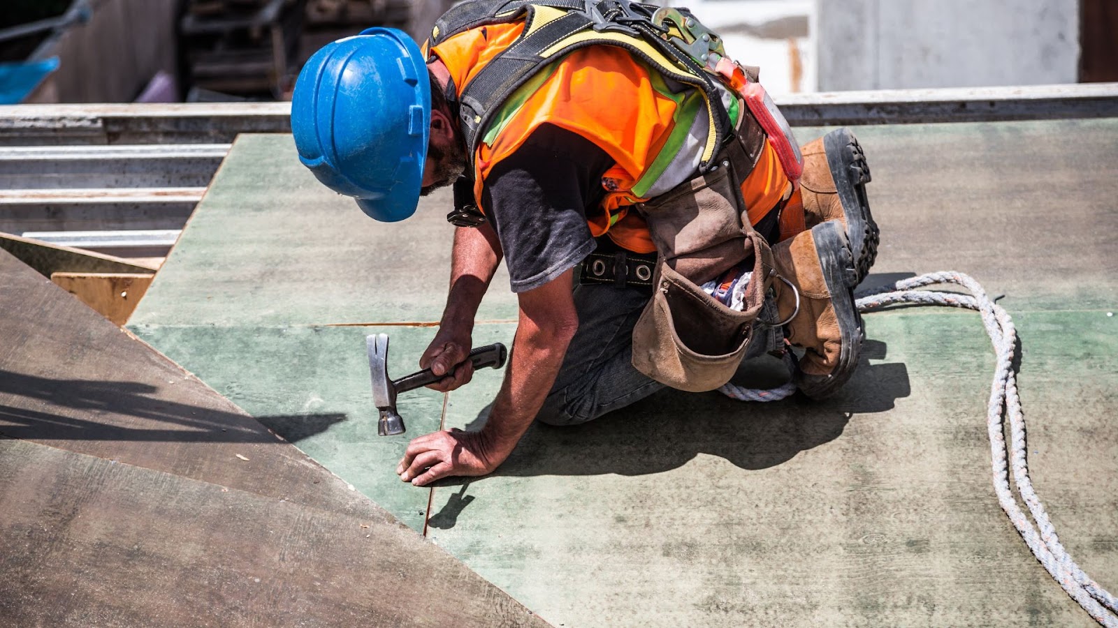 Construction worker working on the roof of a building.